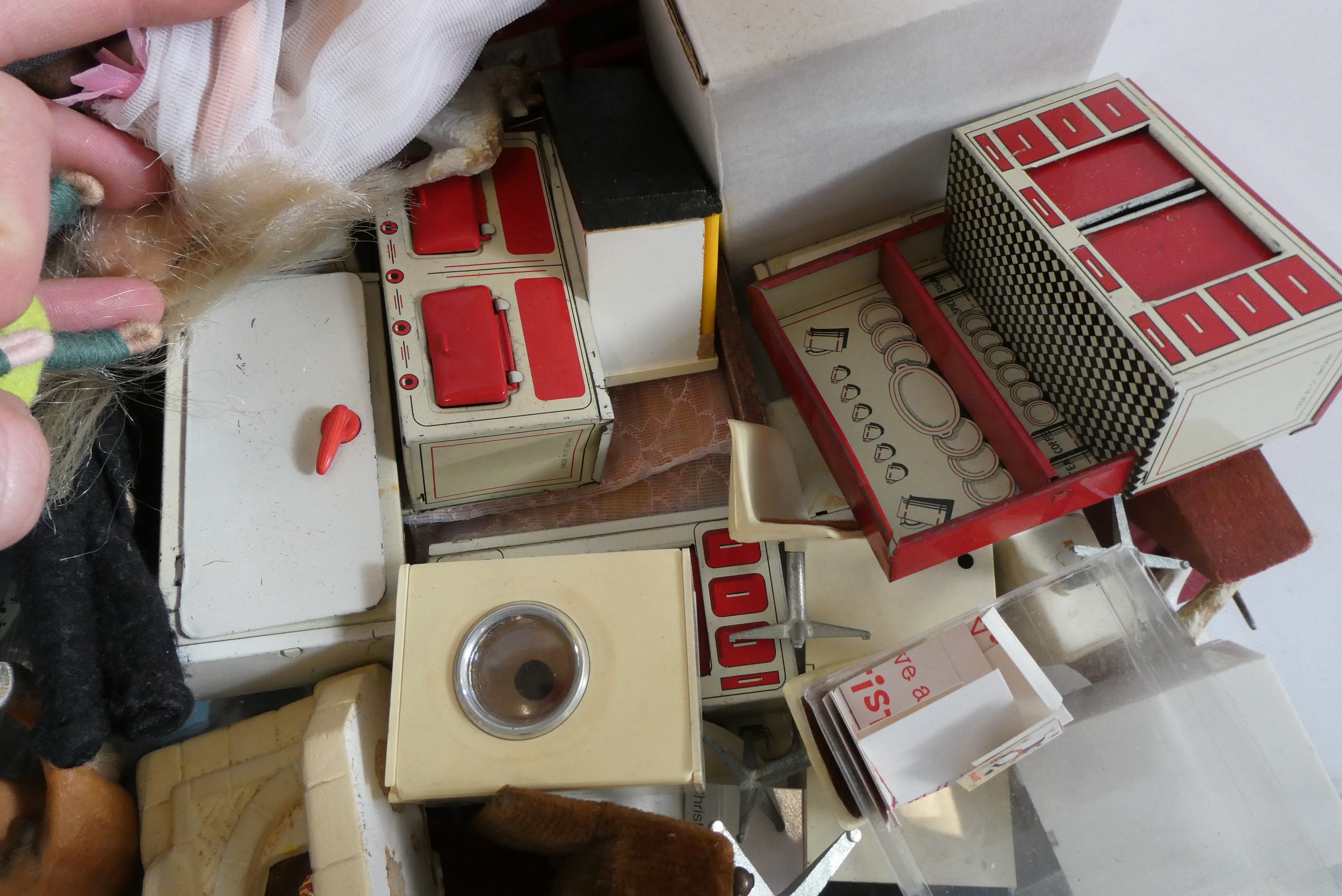 A box of dolls house furniture, dolls and accessories, including a large model telephone box, rugs Image