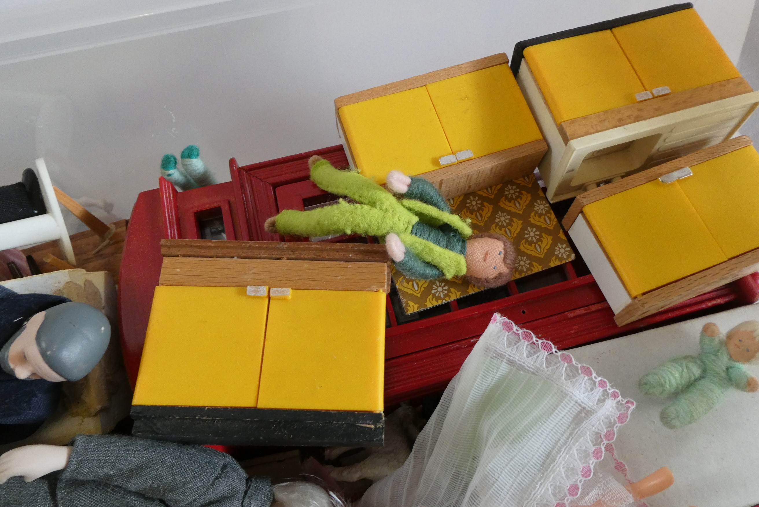 A box of dolls house furniture, dolls and accessories, including a large model telephone box, rugs Image