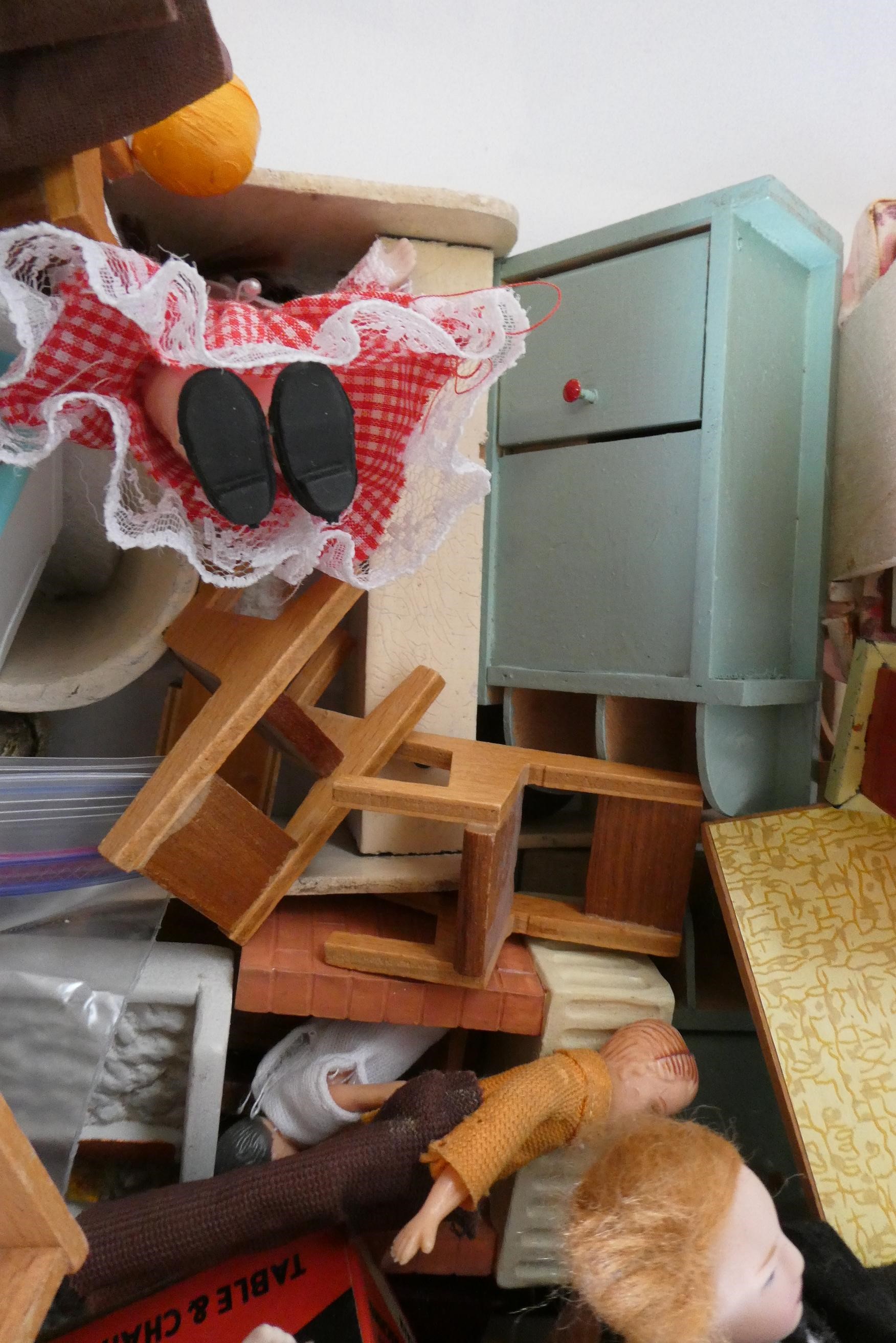 A box of dolls house furniture, dolls and accessories, including a large model telephone box, rugs Image