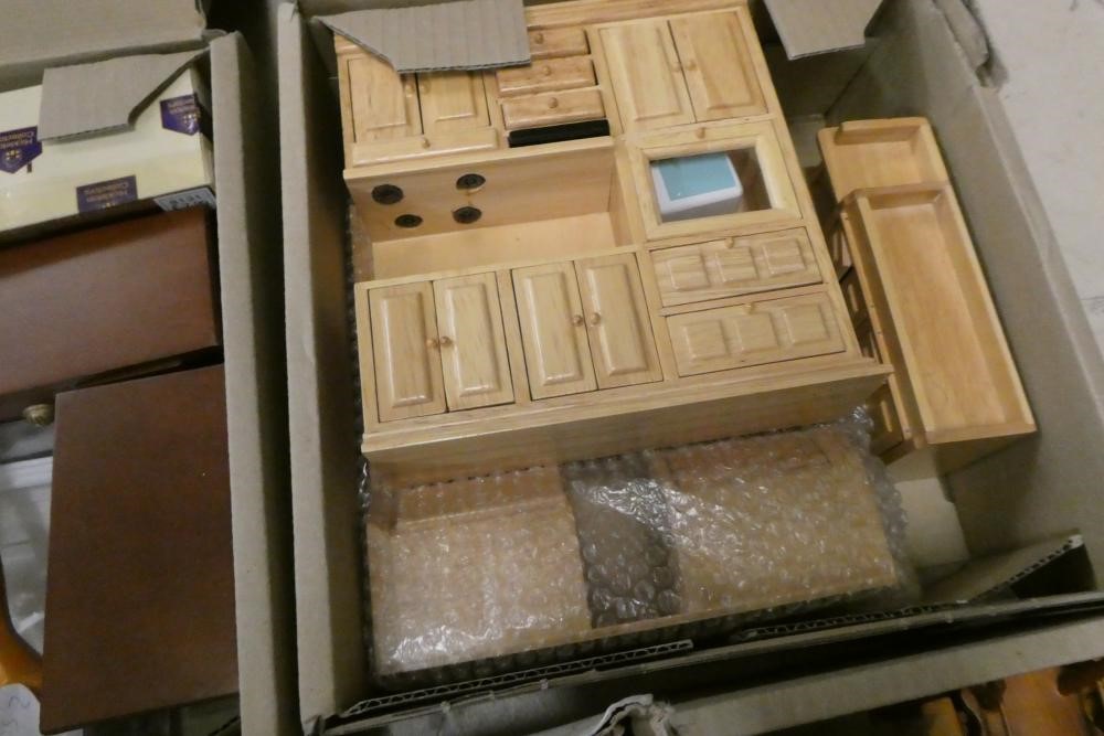 Five boxes of dolls house furniture and accessories, including wood furniture, upholstered suites Image