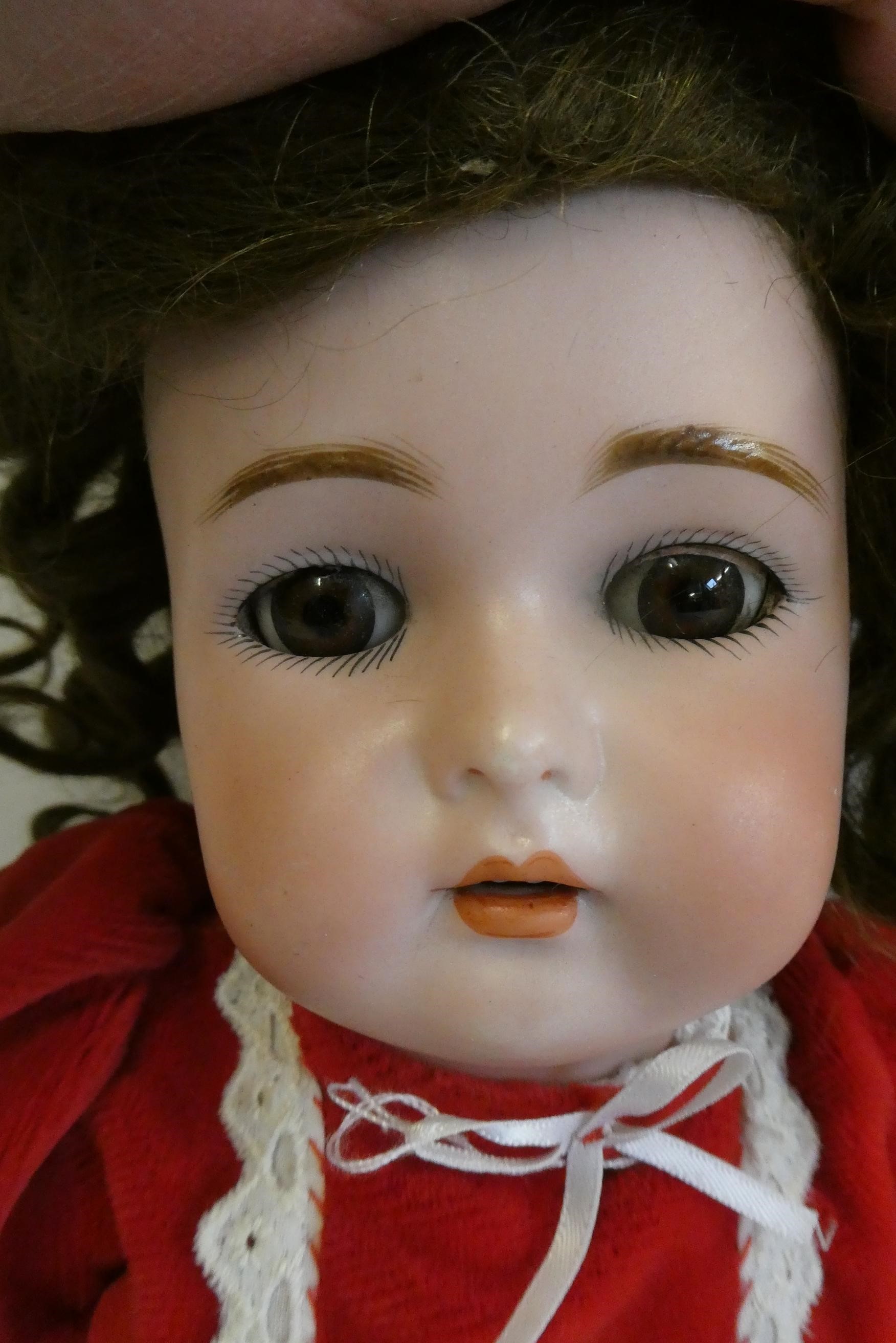 A Kammer & Reinhardt bisque socket head doll, with brown glass sleeping eyes, open mouth, teeth, Image