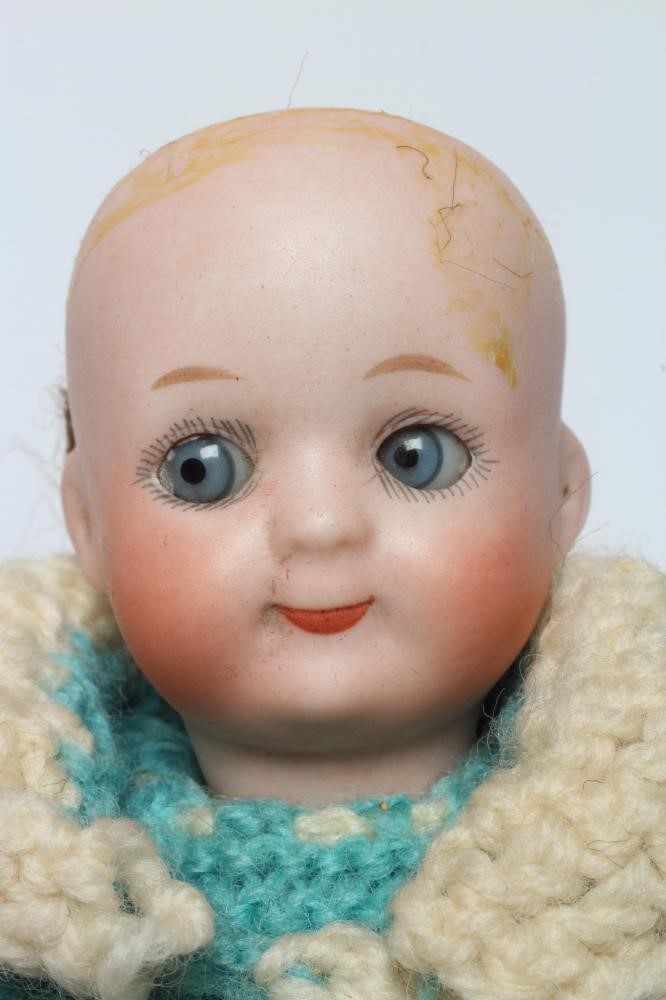 A Heubach bisque socket head googly doll, with blue glass sleepy and sideways glancing eyes, closed Image