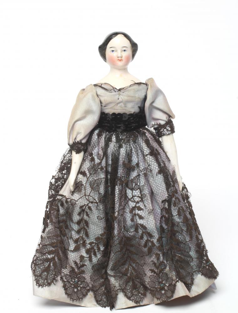 A china shoulder head doll, c.1880, with moulded hair, painted features, fabric body, china lower Image