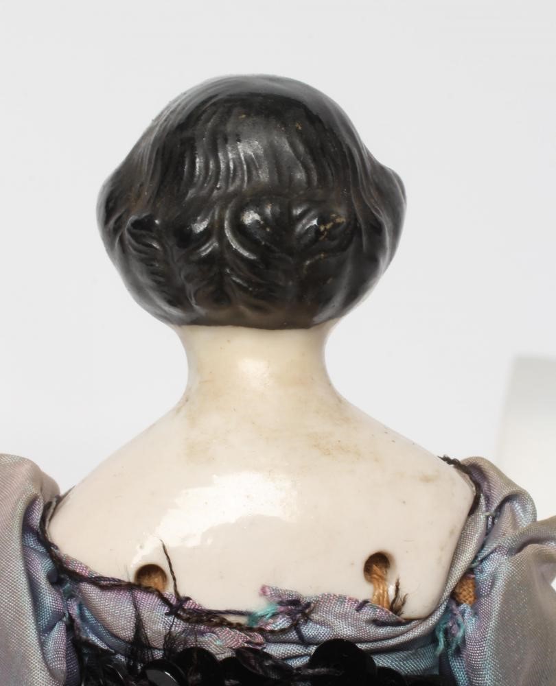 A china shoulder head doll, c.1880, with moulded hair, painted features, fabric body, china lower Image