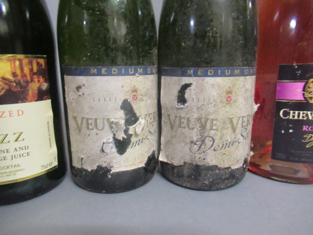 Seven bottles of sparkling wine Image