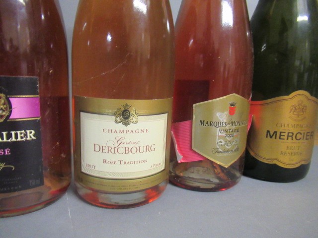 Seven bottles of sparkling wine Image