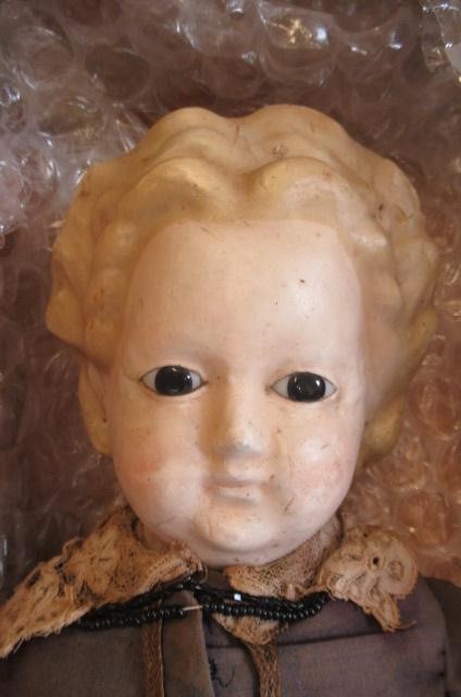 A wax "pumpkin head" doll Image