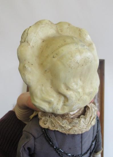 A wax "pumpkin head" doll Image