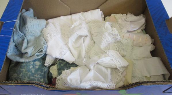 Box of doll's clothing and magazines Image
