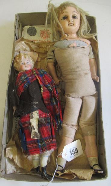 Two antique dolls comprising a 10" Scottish bisque head boy Image