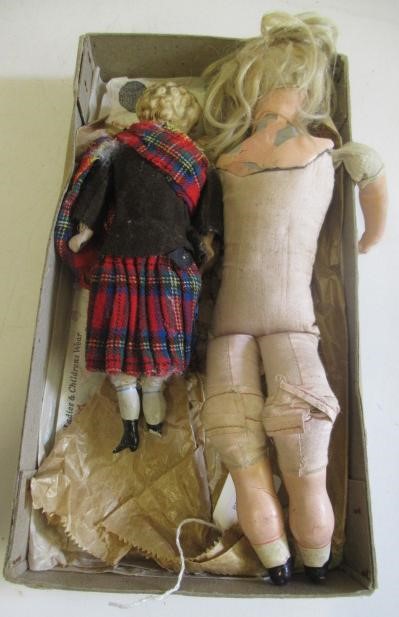 Two antique dolls comprising a 10" Scottish bisque head boy Image