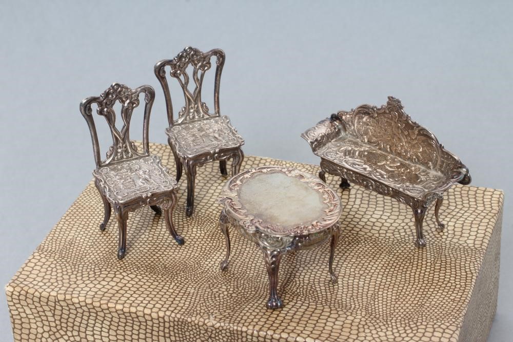 A boxed set of sterling silver doll's house furniture Image