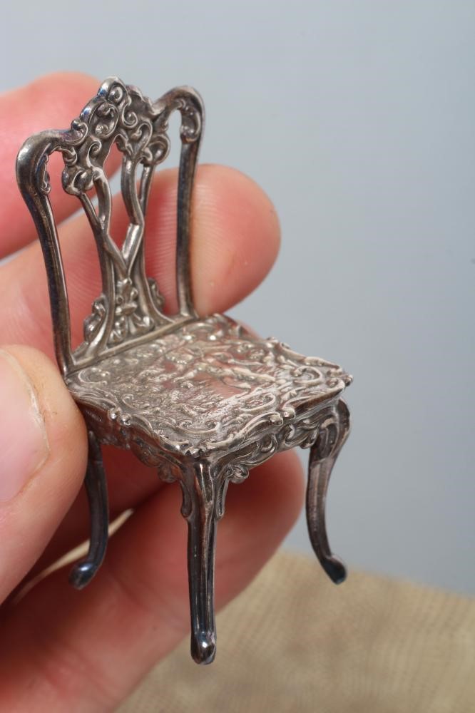 A boxed set of sterling silver doll's house furniture Image