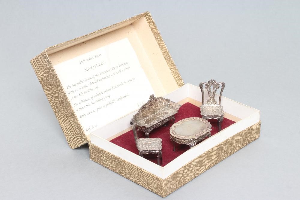 A boxed set of sterling silver doll's house furniture Image