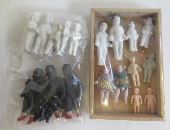 A collection of tiny doll's house dolls Image