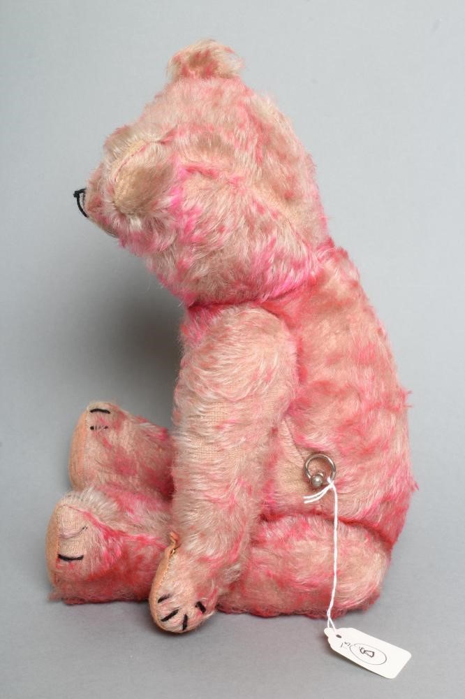 A pre-war pink musical jointed teddy bear Image