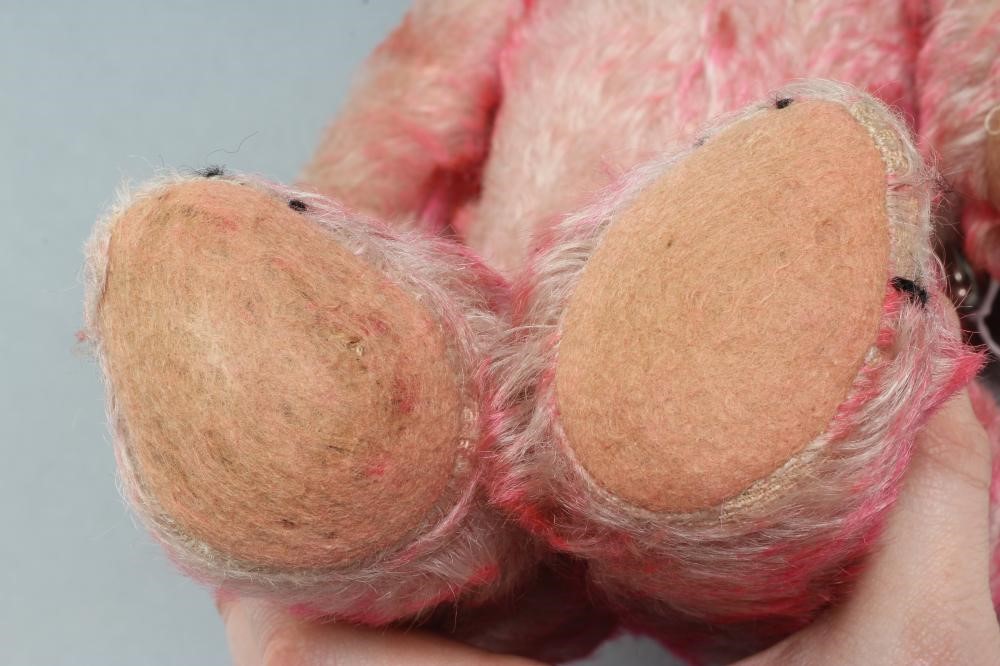 A pre-war pink musical jointed teddy bear Image