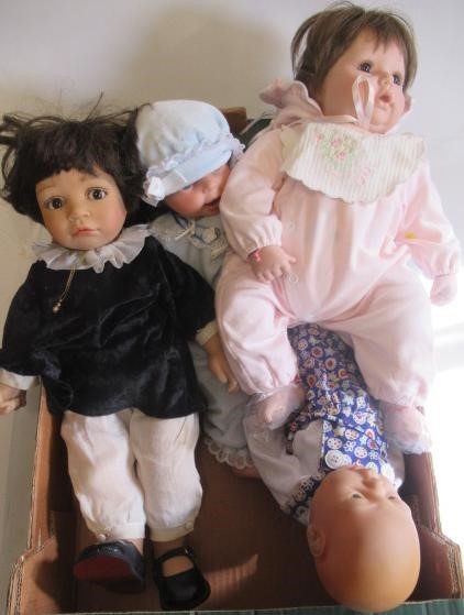 Three boxes of modern dolls Image