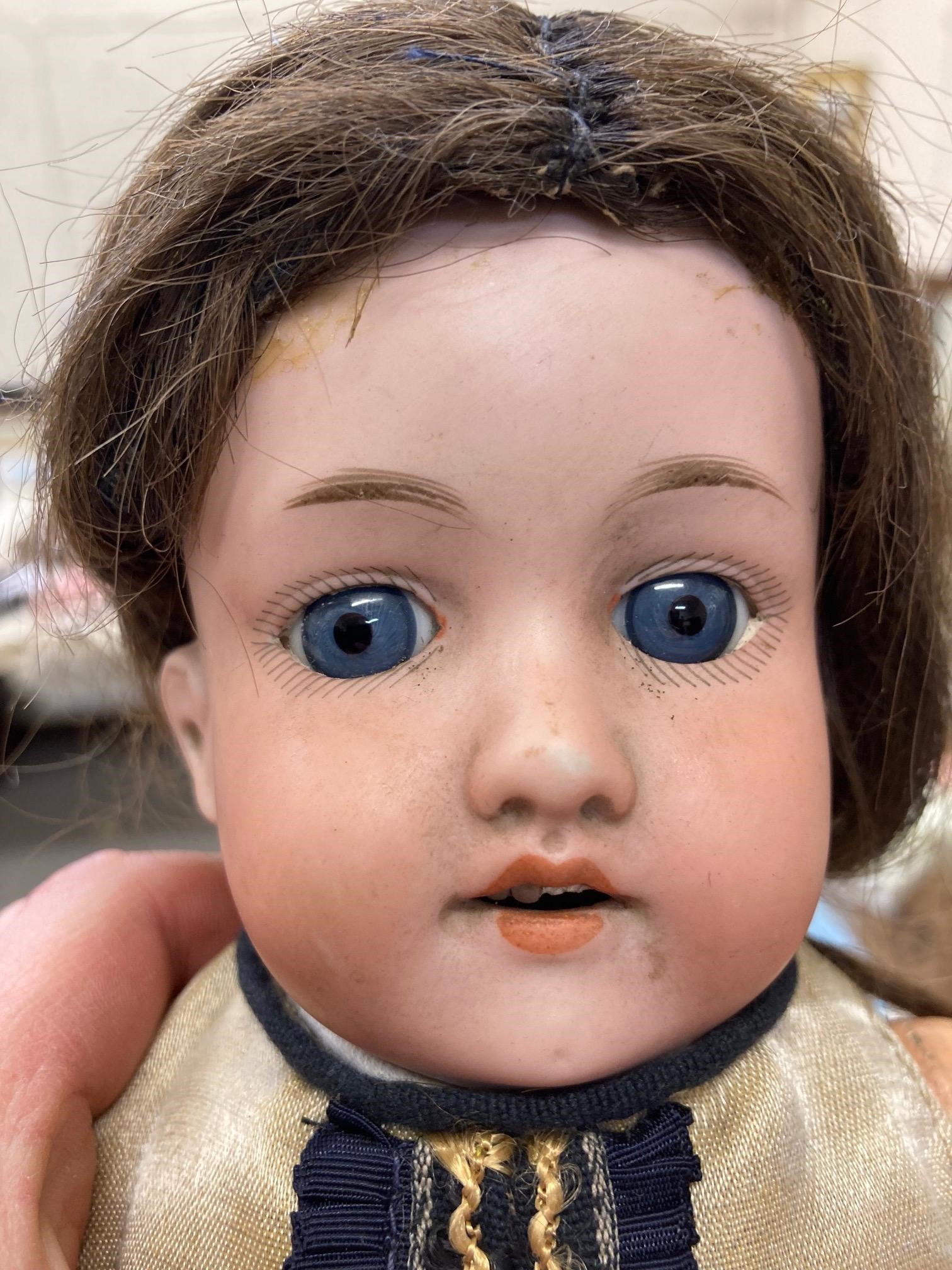 Two bisque socket head dolls, comprising a 14" doll with blue glass fixed eyes, Image