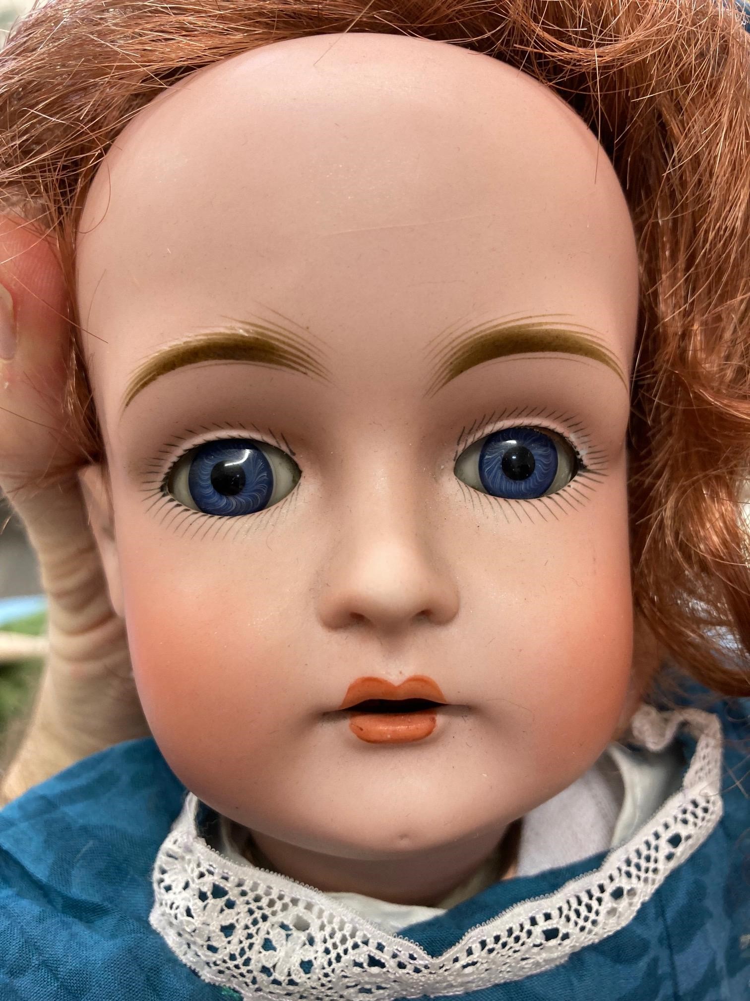 Two bisque socket head dolls, comprising a 14" doll with blue glass fixed eyes, Image