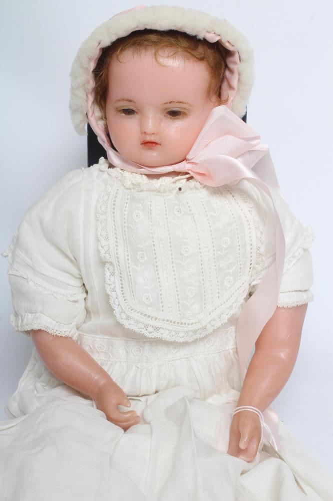 An antique wax shoulder head doll Image