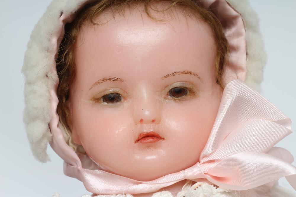 An antique wax shoulder head doll Image