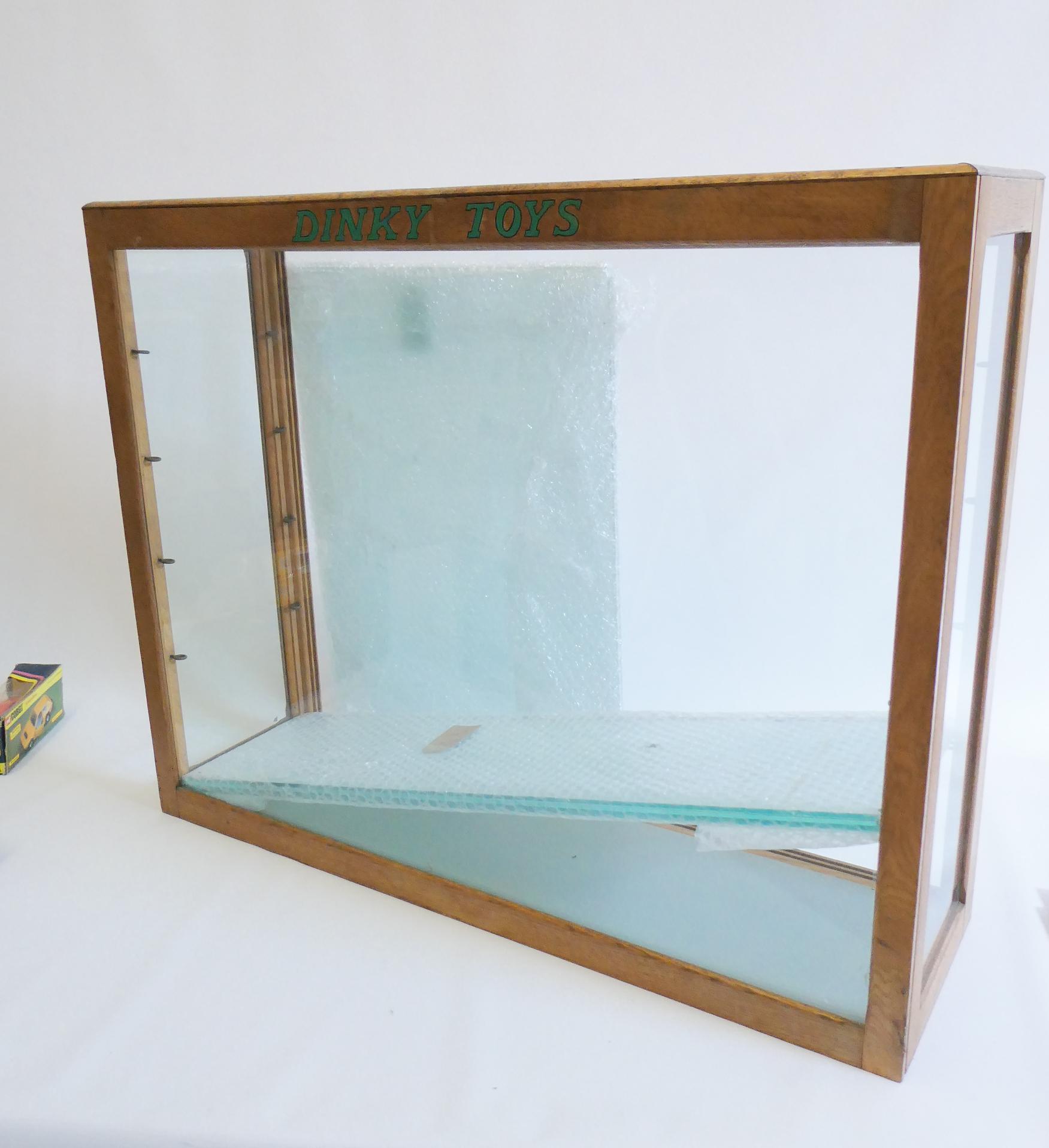 A glass toy shop display cabinet Image