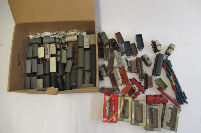 A large quantity of unboxed goods wagons together with five boxed goods wagons Image