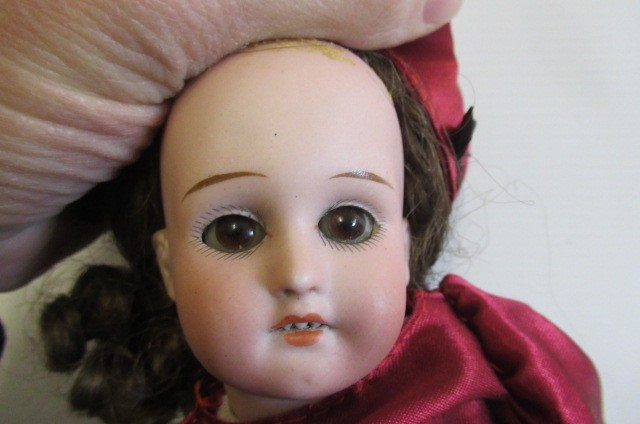 Three bisque head dolls Image