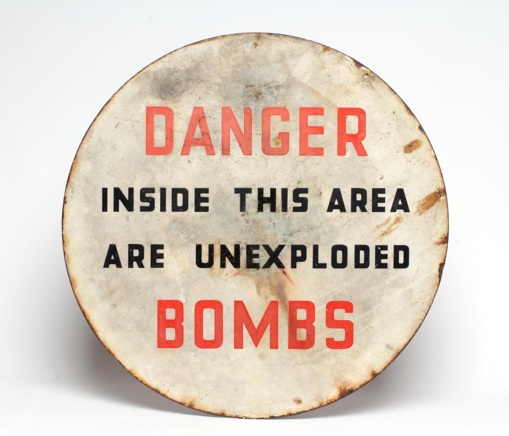 An enamelled un-exploded bomb sign Image