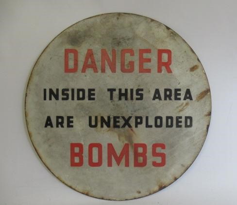 An enamelled un-exploded bomb sign Image