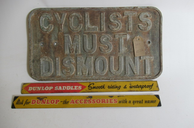 A cast iron Cyclist Must Dismount sign and two small Dunlop tin accessory signs (Est. plus 21% Image