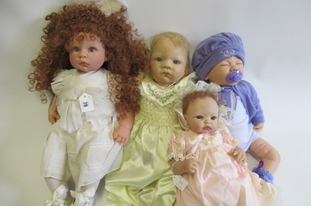 Four dolls comprising a Lee Middleton Reva doll and three Ashton Drake dolls Image