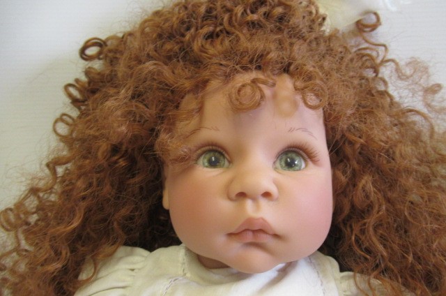 Four dolls comprising a Lee Middleton Reva doll and three Ashton Drake dolls Image