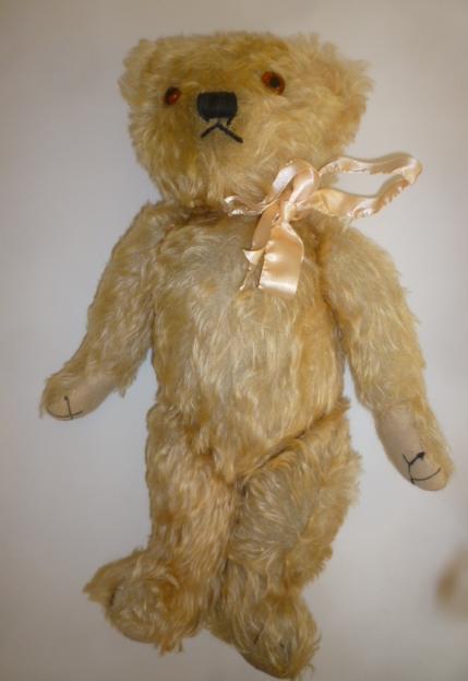 A Merrythought teddy bear covered in pale peach plush Image