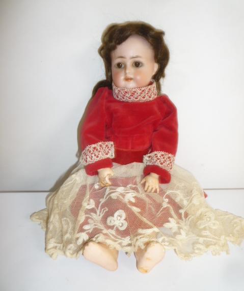 A Kammer & Reinhardt bisque head doll with brown glass sleeping eyes Image