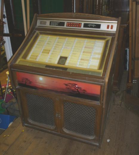 A Rowe "Ami" floor standing juke box with carved wood finish case Image