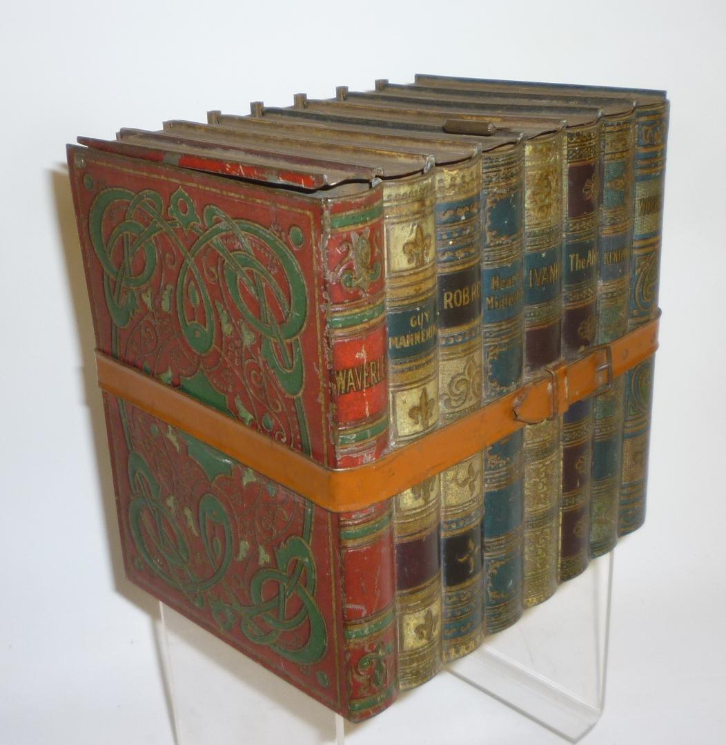 A novelty biscuit tin by Huntley & Palmers in the form of eight novels by Sir Walter Scott tied with Image