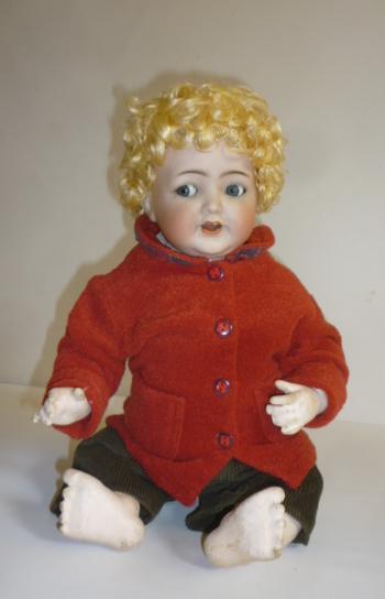 A Kammer & Reinhardt bisque head flirty eyed character doll with blue glass sleeping eyes Image