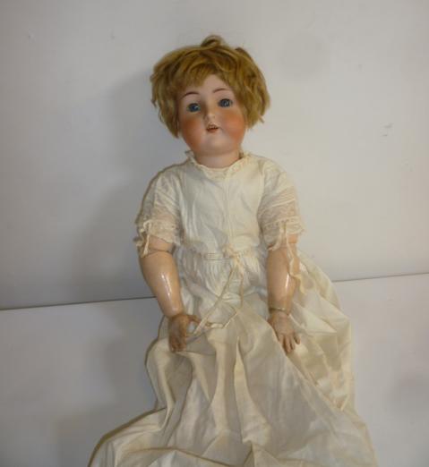 A Kammer & Reinhardt bisque head doll with blue glass sleeping eyes Image