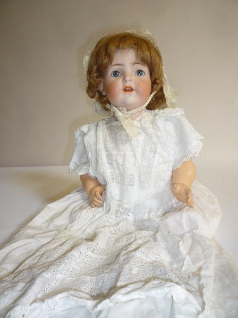 A Simon & Halbig bisque head "Mama" character doll with blue glass sleeping eyes Image
