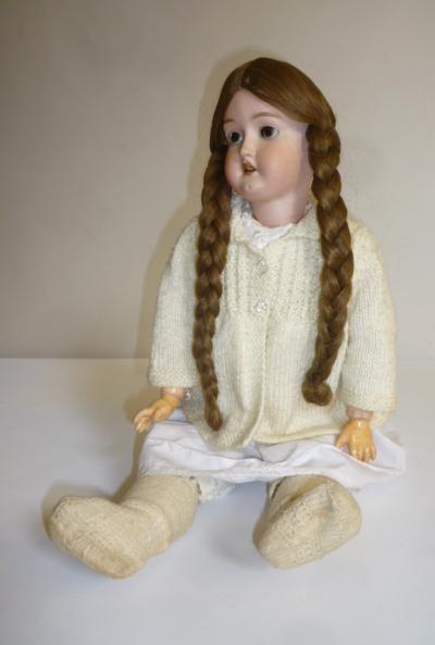 A Simon & Halbig bisque head doll with brown glass sleeping eyes Image