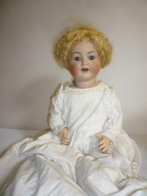 A Kammer & Reinhardt bisque head character doll with blue glass sleeping eyes Image