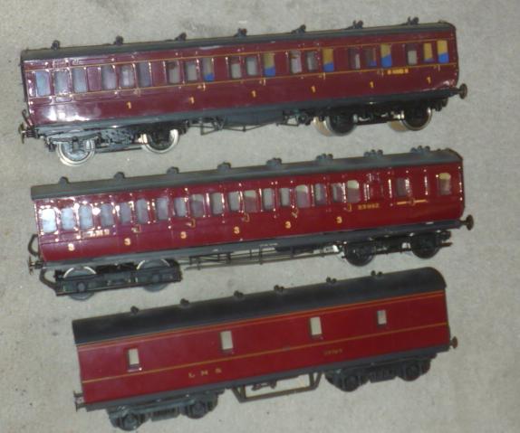 Two kit built L.M.S. panelled suburban coaches finished in red and a L.M.S. motor car van Image