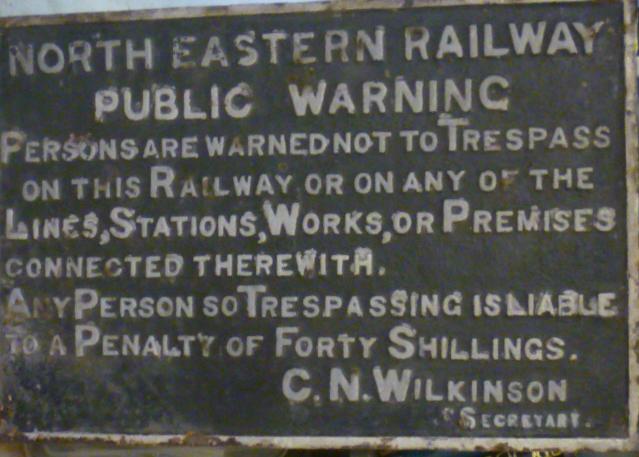 A cast iron sign "North Eastern Railway Public Warning ...Trespass..." with three original iron Image