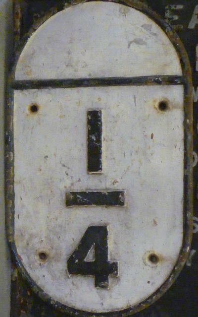 An oval cast iron railway sign to indicate a quarter mile Image