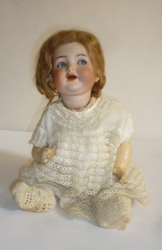 A Kammer & Reinhardt bisque head flirty eyed doll with blue glass sleeping eyes Image