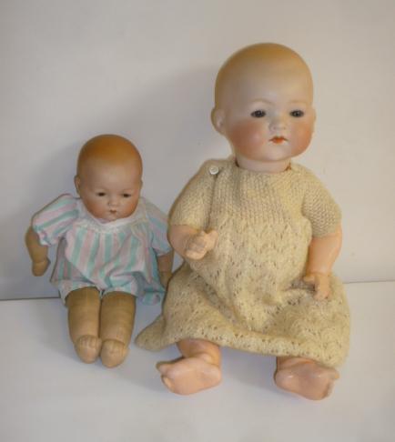 An Armand Marseille bisque head baby doll with blue glass sleeping eyes Image