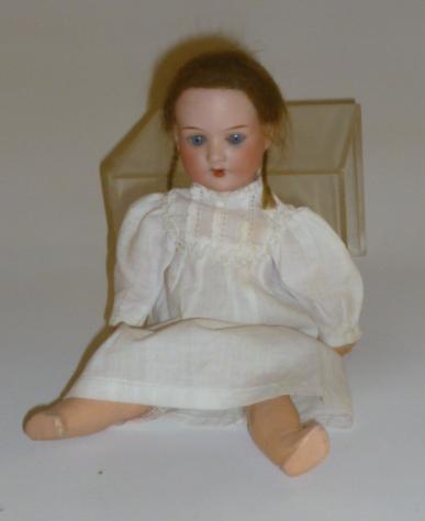 An Armand Marseille bisque head doll with blue glass sleeping eyes Image