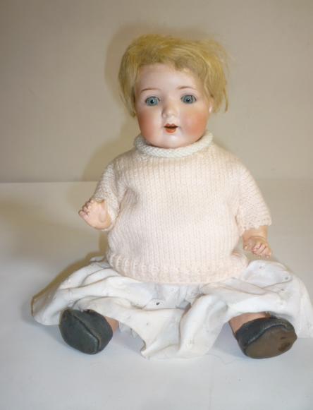 An Armand Marseille bisque head doll with blue glass sleeping eyes Image